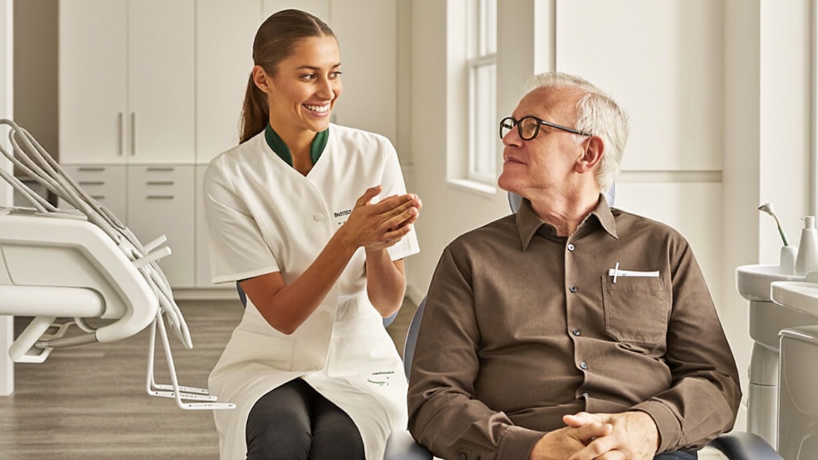 A dentist explaining a treatment plan to a relaxed patient in a bright clinic