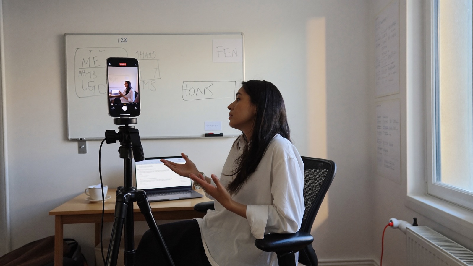 A software founder recording a short video about her product in a small office